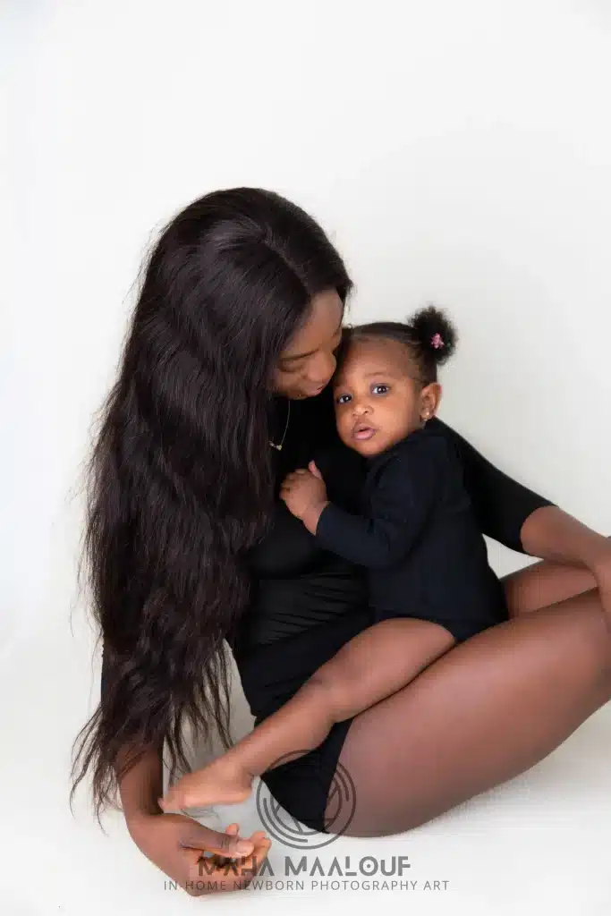 Mother cuddling her baby during a relaxed family photo session at home