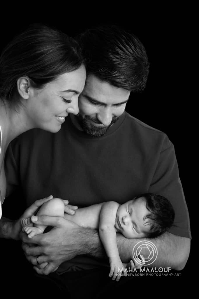 Parents holding their newborn baby during family photography session