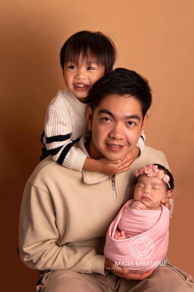 Parents holding their newborn baby during family photography session