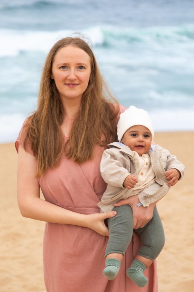 Mother holding her baby during a family photo session at the beach