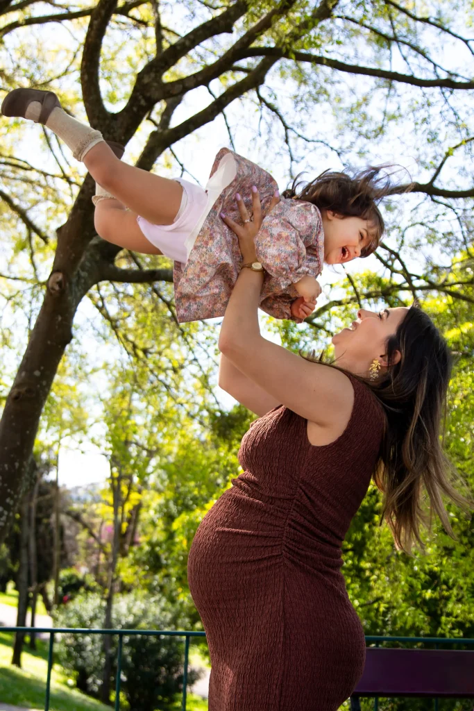 Mother lifting her child during a maternity family photo session